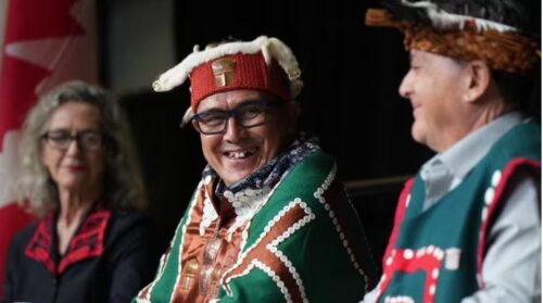 CBC news image: Chief Winidi (John Powell), centre, of the Mamalilikulla First Nation, sits with Fisheries Minister Joyce Murray, left, and former chief Richard Sumner during an announcement about a new marine refuge in the Gwaxdlala/Nalaxdlala (Lull Bay/Hoeya Sound) area in Knight Inlet on B.C.'s central coast, at the International Marine Protected Areas Congress (IMPAC5) in Vancouver, on Sunday. (Darryl Dyck/The Canadian Press)
